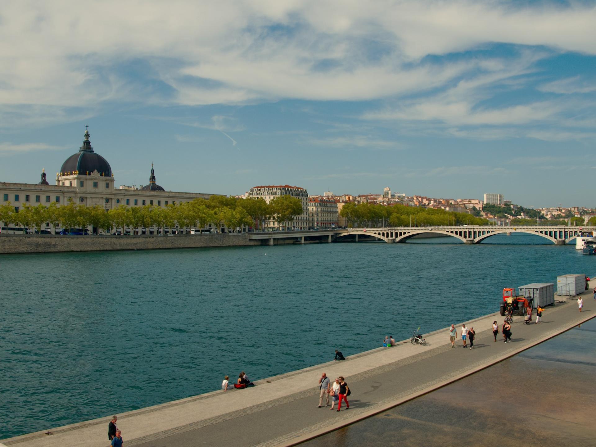 people walking beside river